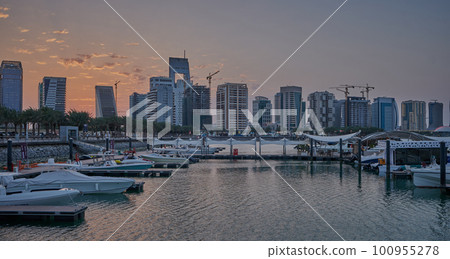 Lusail marina in Lusail city, Qatar sunset view with Yachts and boats with Qatar flag ,Lusail skyline and clouds in the sky in in background Lusail marina in Lusail city, Qatar sunset view with Yachts and boats with Qatar flag ,Lusail skyline and clouds in the sky in in background 100955278