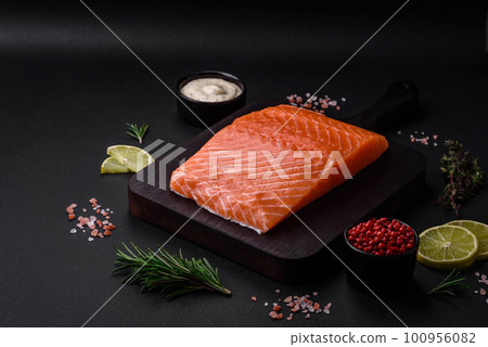 Fresh tasty raw red fish fillet with spices and herbs 100956082