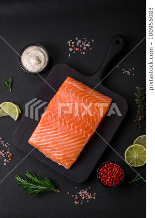 Fresh tasty raw red fish fillet with spices and herbs 100956083
