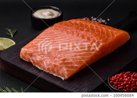 Fresh tasty raw red fish fillet with spices and herbs Fresh tasty raw red fish fillet with spices and herbs 100956084