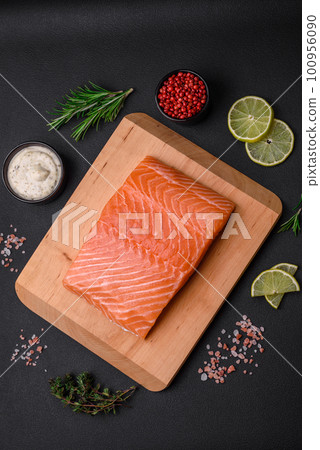 Fresh tasty raw red fish fillet with spices and herbs Fresh tasty raw red fish fillet with spices and herbs 100956090