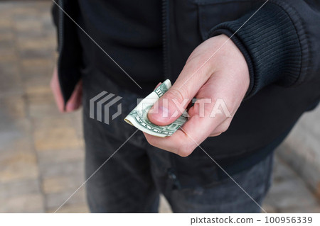 Addiction concept. Money in the dealer hand close-up Addiction concept. Money in the dealer hand close-up 100956339