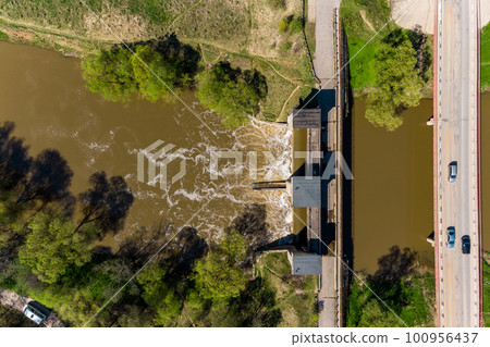 View from a high altitude of a dam on the river and a road bridge. Obninsk, Russia View from a high altitude of a dam on the river and a road bridge. Obninsk, Russia 100956437