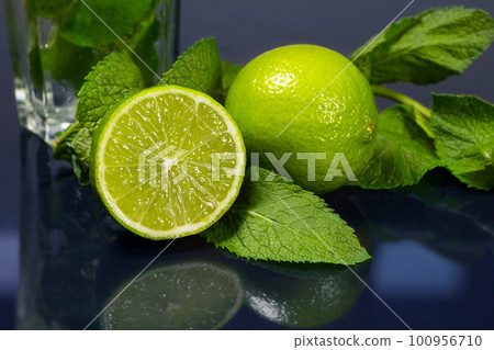Fresh green mint and lime close-up on a dark background. Lime slice 100956710
