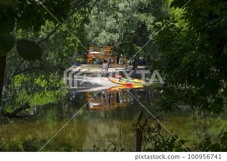 Kayaks, boats on the river bank. Beautiful nature. Healthy lifestyle Kayaks, boats on the river bank. Beautiful nature. Healthy lifestyle 100956741