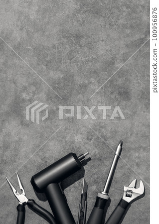 Flat lay composition with set of home repair tools on grey stone background. Top view pattern with copy space. 100956876