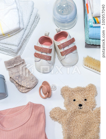 Set of baby shoes, toys and accessories on white background. Newborn stuff. Flat lay, top view 100957040