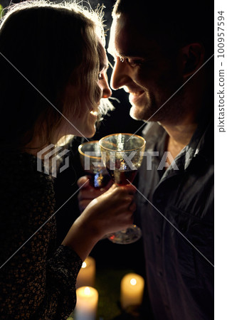Romantic Couple with Wine Glasses and Candles 100957594