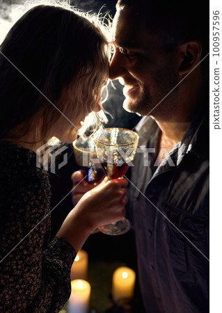 Romantic Couple with Wine Glasses and Candles 100957596
