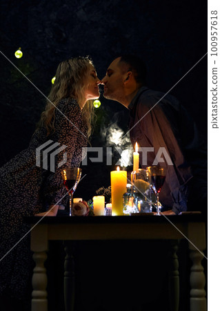 Candlelit Dinner with Romantic Kiss in Night Restaurant Candlelit Dinner with Romantic Kiss in Night Restaurant 100957618