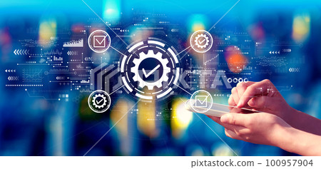 Quality control approval with person using a smartphone at night Quality control approval with person using a smartphone at night 100957904