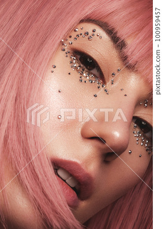 Beautiful woman in a pink wig and creative makeup with rhinestones. Beauty face. 100959457