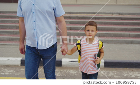 Child crosswalk hand backpack school run student boy father pedestrian crossing zebra pedestrian car sign road. family striped traffic rule highway group brother sister man primary outside move 100959755