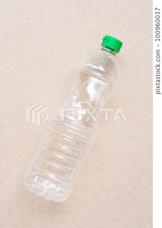 Plastic bottle on brown background. 100960037