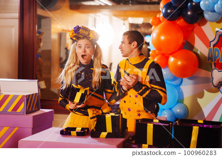 man and woman actors play at a children's party. man and woman actors play at a children's party. 100960283