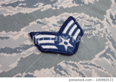 August 31, 2020. US AIR FORCE Senior Airman rank patch on digital tiger-stripe pattern Airman Battle Uniform (ABU) background August 31, 2020. US AIR FORCE Senior Airman rank patch on digital tiger-stripe pattern Airman Battle Uniform (ABU) background 100960515