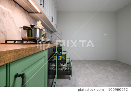 Green and white colored modern kitchen details closeup Green and white colored modern kitchen details closeup 100960952