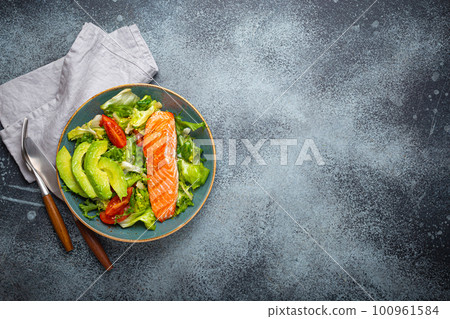 Grilled fish salmon steak and vegetables salad with avocado on ceramic plate on rustic stone background top view, balanced diet, healthy nutrition salad meal with salmon and veggies, space for text Grilled fish salmon steak and vegetables salad with avocado on ceramic plate on rustic stone background top view, balanced diet, healthy nutrition salad meal with salmon and veggies, space for text 100961584