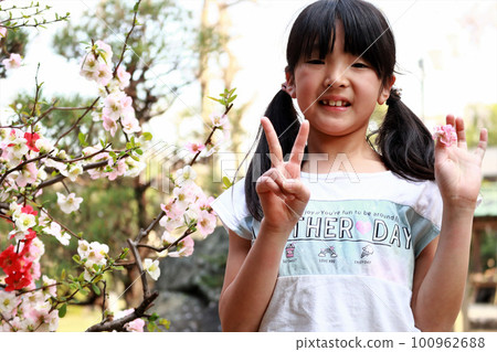 Girl posing under cherry blossoms Girl posing under cherry blossoms 100962688
