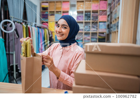 muslim woman owner checking the product before shipping muslim woman owner checking the product before shipping 100962782