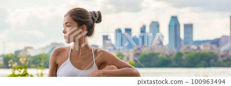 Asian woman doing yoga stretch for back outside in city park skyline panoramic banner. Fit girl teacher stretching outdoors on summer day Asian woman doing yoga stretch for back outside in city park skyline panoramic banner. Fit girl teacher stretching outdoors on summer day 100963494