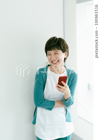 A young woman using a smartphone A young woman using a smartphone 100963516