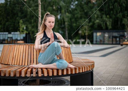 Girl practice yoga and meditation in the city. 100964421