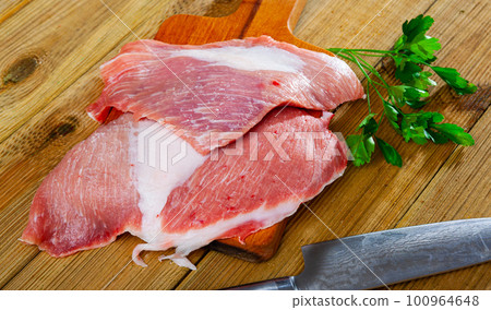 Raw pork secreto fillet and greens Raw pork secreto fillet and greens 100964648