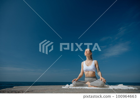 Yoga practice and meditation in nature. Woman practicing near Black sea. Yoga practice and meditation in nature. Woman practicing near Black sea. 100964663