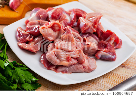 Fresh raw chicken stomachs with spices on wooden table Fresh raw chicken stomachs with spices on wooden table 100964697
