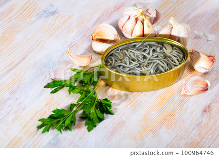 Eel fry with garlic in open tin Eel fry with garlic in open tin 100964746