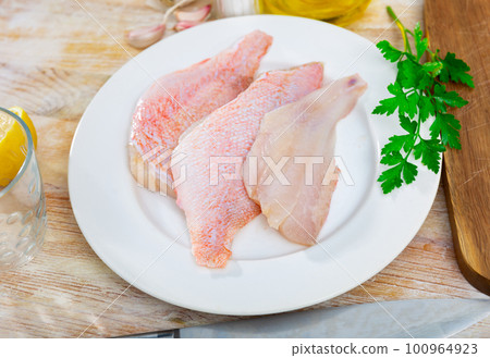 Fresh raw fillet of sea bass Fresh raw fillet of sea bass 100964923
