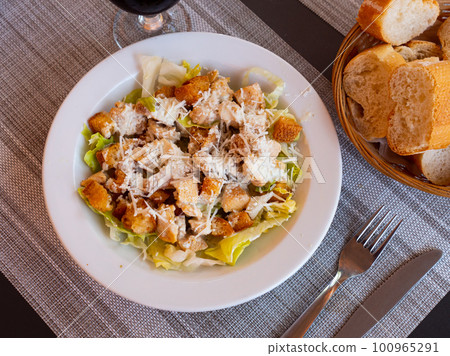Fresh Caesar salad with chicken on plate Fresh Caesar salad with chicken on plate 100965291