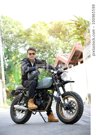 Asian man motorbike in black leather jacket travel rider trip. Handsome Men wear sunglass outdoor lifestyle freedom rider. Men trendy hipster cool person. Young asian man hobby ride with motor bike 100965599