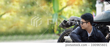Banner Asian man motorbike in black leather jacket travel rider trip. Panorama Handsome Men wear sunglass outdoor lifestyle freedom rider. Hipster asian man hobby ride motor bike with copy space 100965601