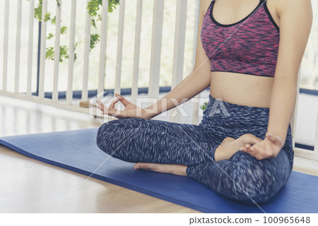 Asana yoga Beautiful woman smiling in sportswear sitting on yoga mat home fitness happy wellness lifestyle. Smiling asian woman doing asana yoga body, leg stretching in living room home fitness sport Asana yoga Beautiful woman smiling in sportswear sitting on yoga mat home fitness happy wellness lifestyle. Smiling asian woman doing asana yoga body, leg stretching in living room home fitness sport 100965648