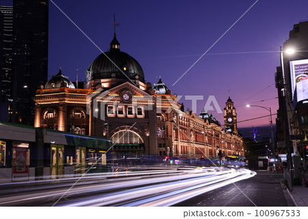 Long exposure shot in front of Flinders Street Station in Melbourne Australia at night 100967533