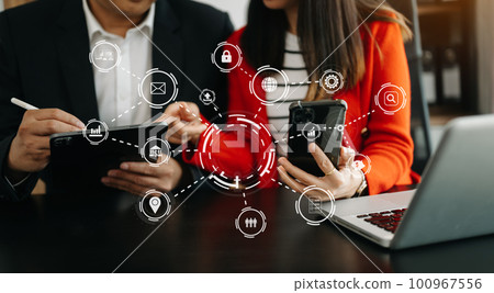 Business team partnership meeting concept. Business hand using laptop, tablet and smartphone  in office. Digital marketing media mobile app in virtual icon screen in morning light. 100967556