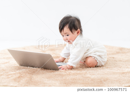 baby playing with computer baby playing with computer 100967571