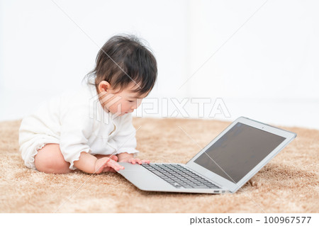 baby playing with computer baby playing with computer 100967577