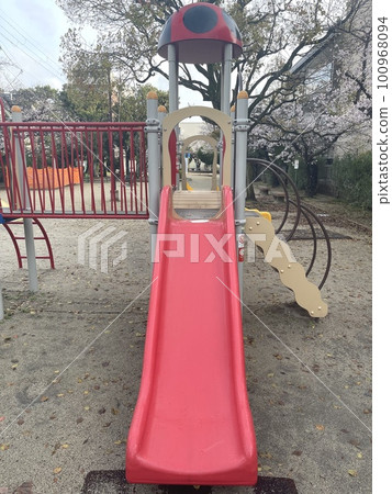 Cherry blossoms and playground equipment in a small park Chuo-dori, Ibaraki City, Osaka Prefecture 100968094