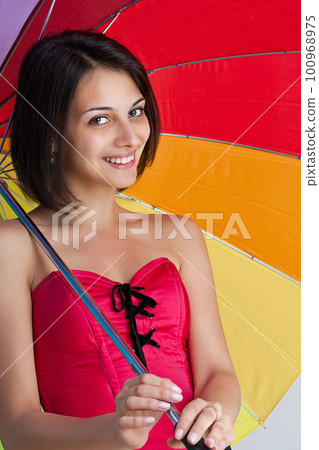 Woman with rainbow umbrella 100968975