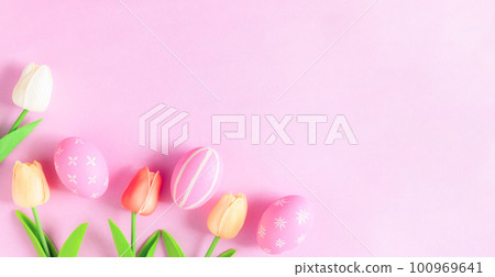 Happy Easter holiday greeting card concept. Colorful Easter Eggs and spring flowers on pastel pink background. Flat lay, top view, copy space. Happy Easter holiday greeting card concept. Colorful Easter Eggs and spring flowers on pastel pink background. Flat lay, top view, copy space. 100969641