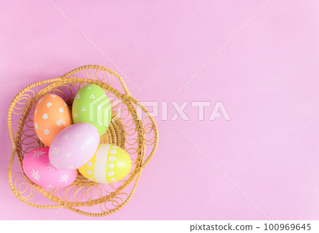 Happy Easter holiday greeting card concept. Colorful Easter Eggs and spring flowers on pastel pink background. Flat lay, top view, copy space. Happy Easter holiday greeting card concept. Colorful Easter Eggs and spring flowers on pastel pink background. Flat lay, top view, copy space. 100969645