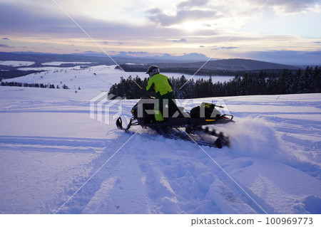 early morning snowmobile 100969773
