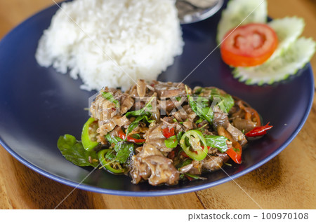 Stir Fried Basil with Stewed Pork on Rice popular traditional Thai food. side view Stir Fried Basil with Stewed Pork on Rice popular traditional Thai food. side view 100970108