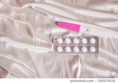 Contraceptive pills and a negative pregnancy test kit showing womens health, universal healthcare and equality concept Contraceptive pills and a negative pregnancy test kit showing womens health, universal healthcare and equality concept 100970428