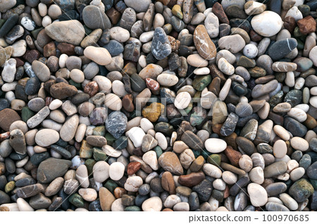 Smooth round wet pebbles texture background. Pebble sea beach close-up. Smooth round wet pebbles texture background. Pebble sea beach close-up. 100970685