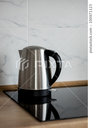 electric kettle on the stove kitchen. 100971123