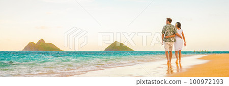 Couple walking on beach sunset vacation panoramic hawaii travel. Woman and man relaxing on tourist holiday in Lanikai, Oahu, Hawaii banner. 100972193